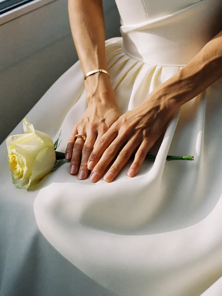 Their hands with wedding rings